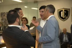 Guests in conversation in the office lobby during the opening