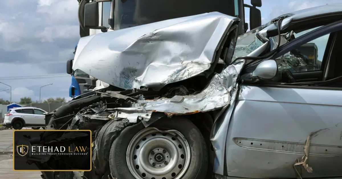 Passenger car crushed against the front of a commercial truck after a collision – Etehad Law.