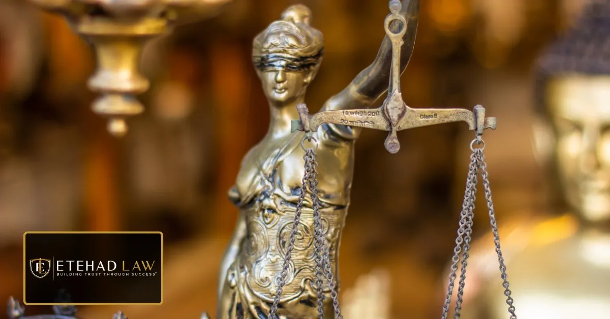 Brass statue of Lady Justice holding a set of balanced scales