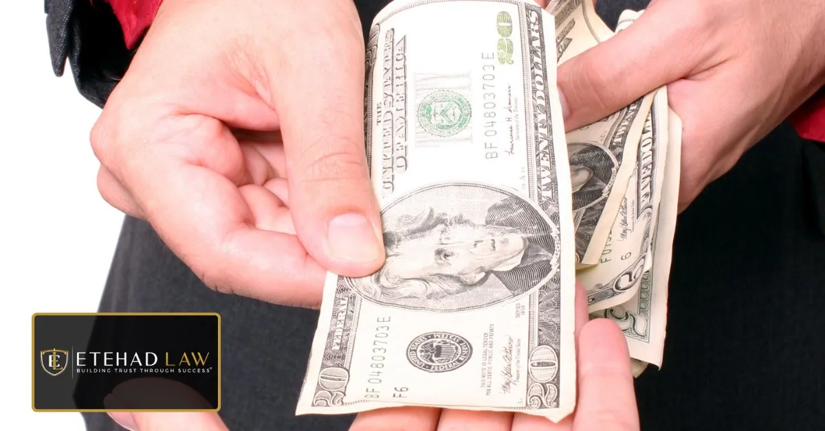Hands counting twenty dollar bills, representing money a homeowner paid to an unlicensed contractor