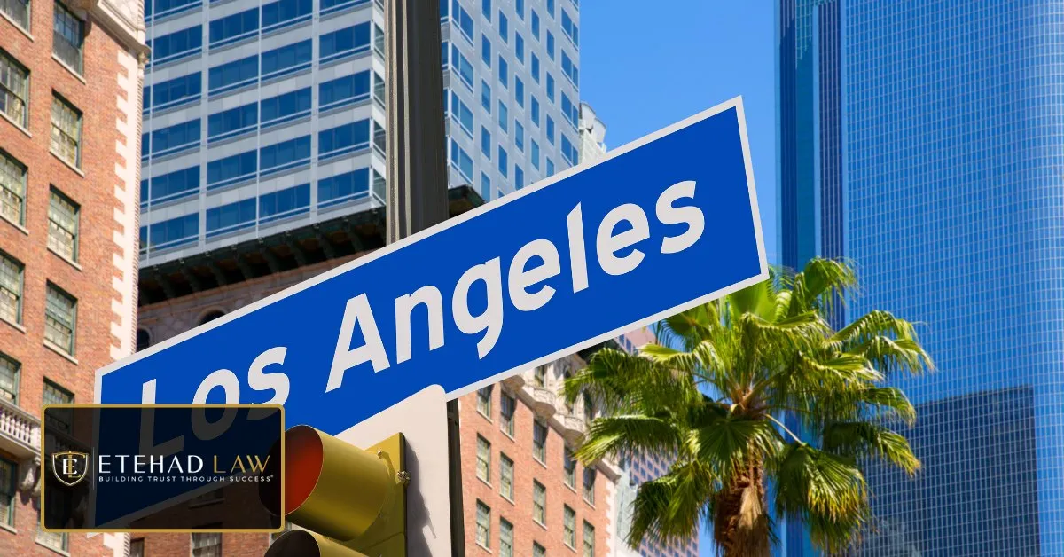 A Los Angeles street sign against downtown high-rises and a palm tree