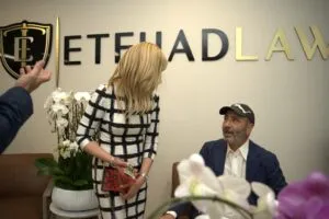 Guests seated in front of the Etehad Law wall sign during the party