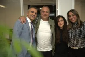 Four guests posing together at the office opening