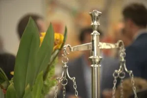 Close-up of a scales of justice statue beside flowers in the office