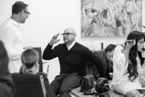 Black-and-white photo of a guest raising a glass at the reception