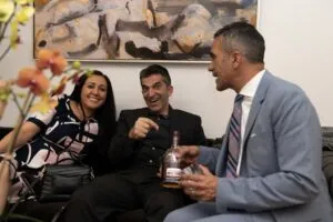 Guests seated together with drinks during the opening celebration