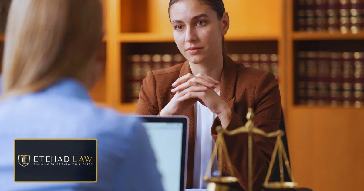 Attorney listening to a client during a legal consultation in a law office – Etehad Law.