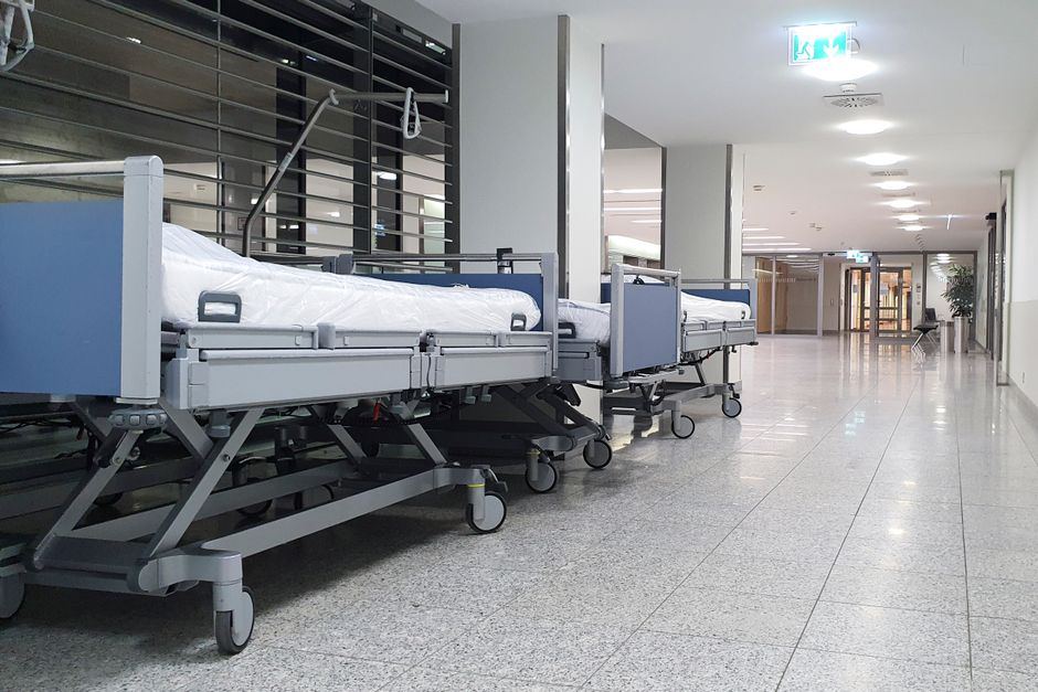 Empty hospital corridor with gurneys representing car accident injury treatment