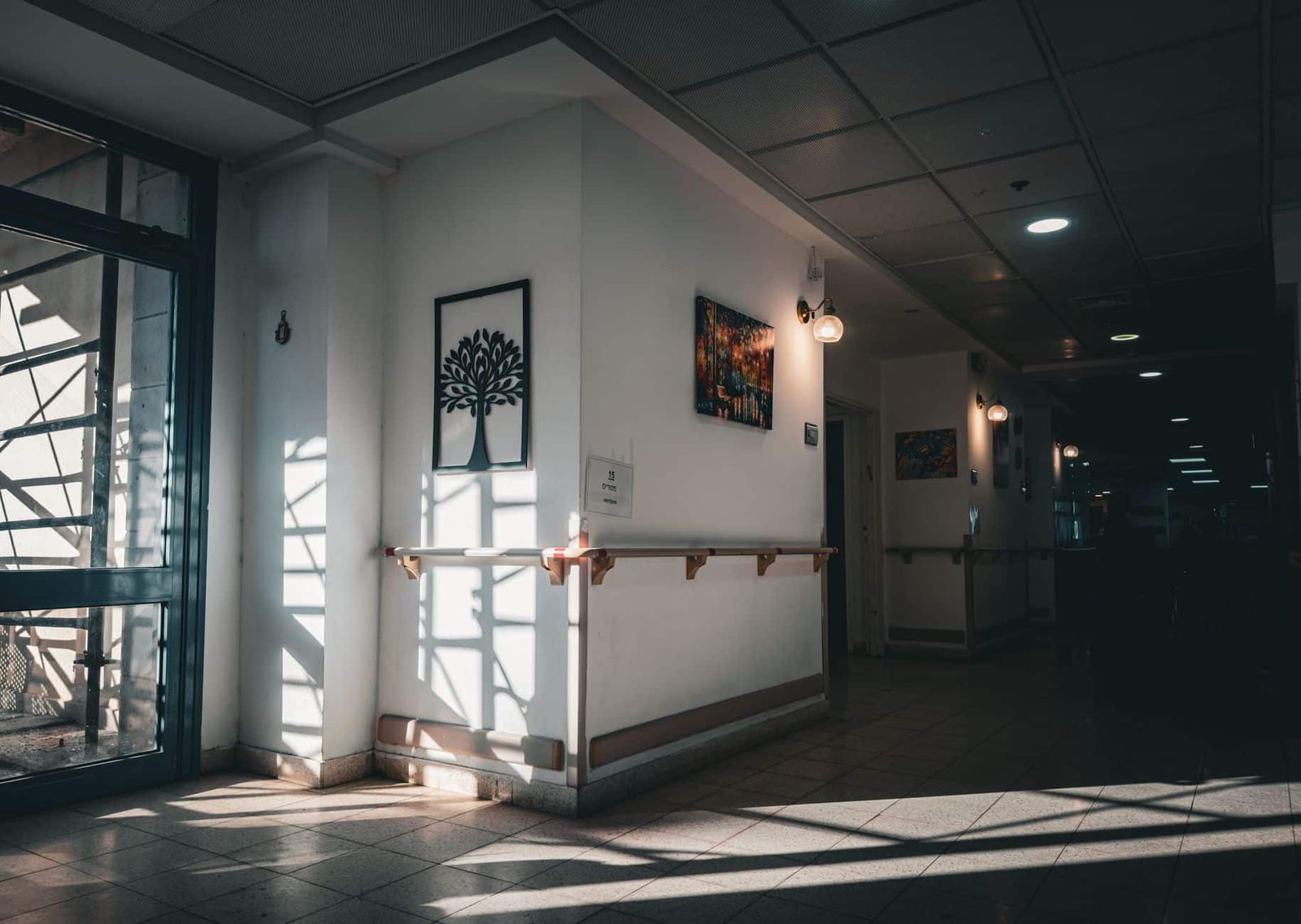 Quiet Beverly Hills nursing home corridor with handrails and natural light